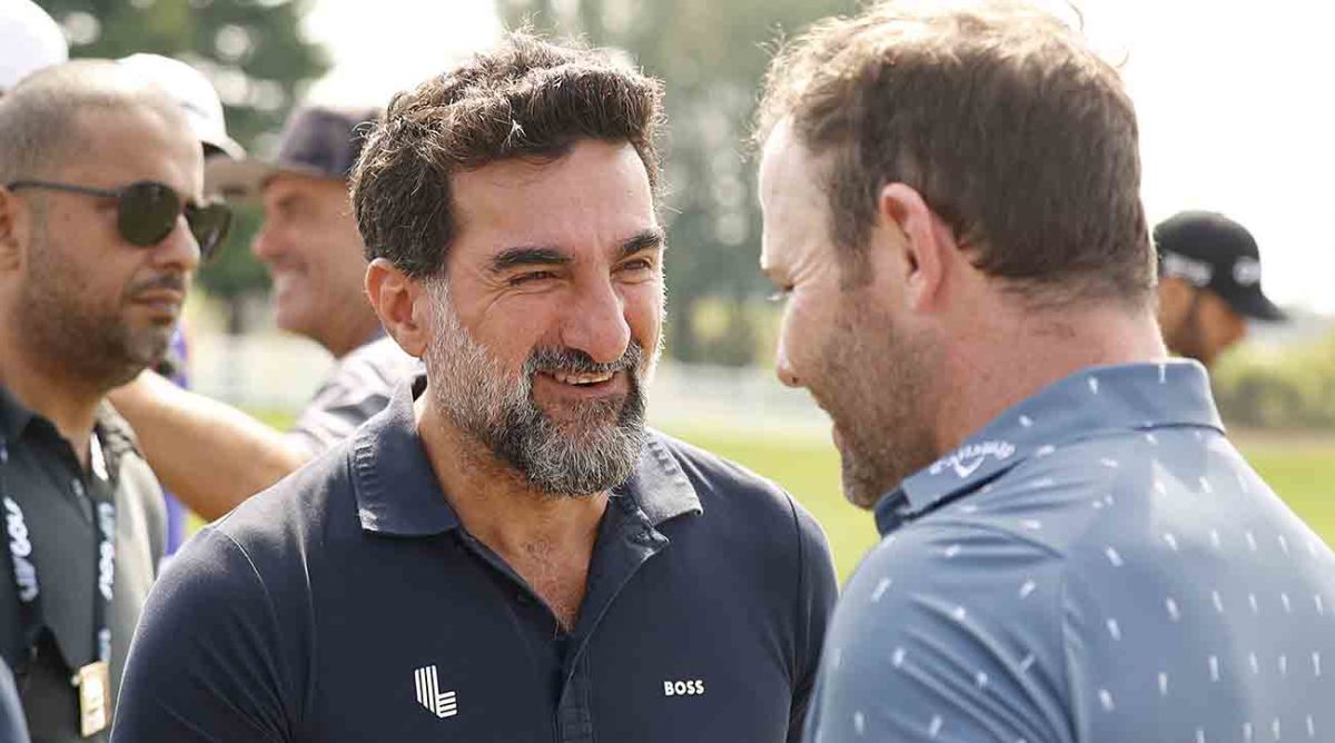 Yasir Al-Rumayyan, governor of Saudi Arabia s Public Investment Fund, talks with player Branden Grace on the practice range before the start of the second round of the 2022 LIV Golf Invitational Series Chicago.