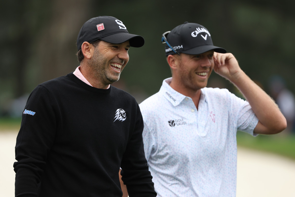 Sergio Garcia of Spain and Talor Gooch of the United States laugh on the third hole during a practice round prior to the 2023 Masters Tournament at Augusta National Golf Club.