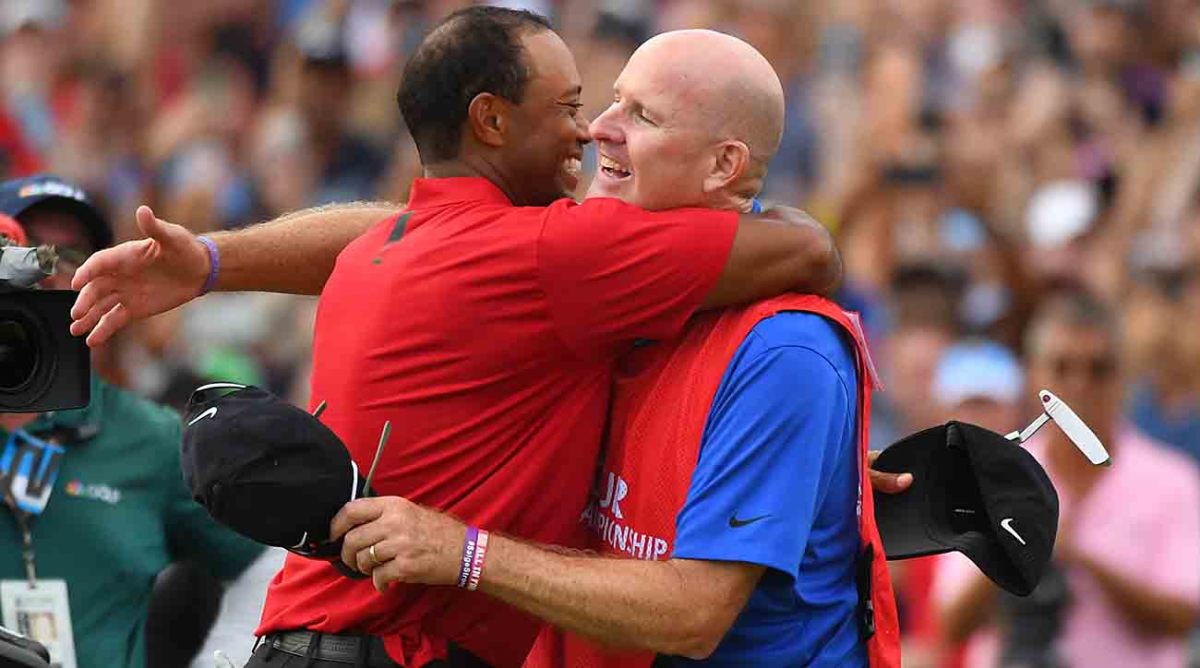Tiger Woods hugs his caddie Joe LaCava after winning the 2018 Tour Championship golf tournament at East Lake Golf Club.