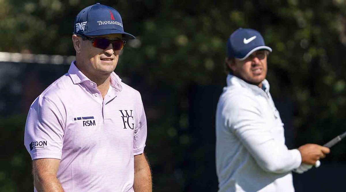 Zach Johnson (left) watches Brooks Koepka (right) tee shot on the fifth hole during a practice round at the 2023 British Open.