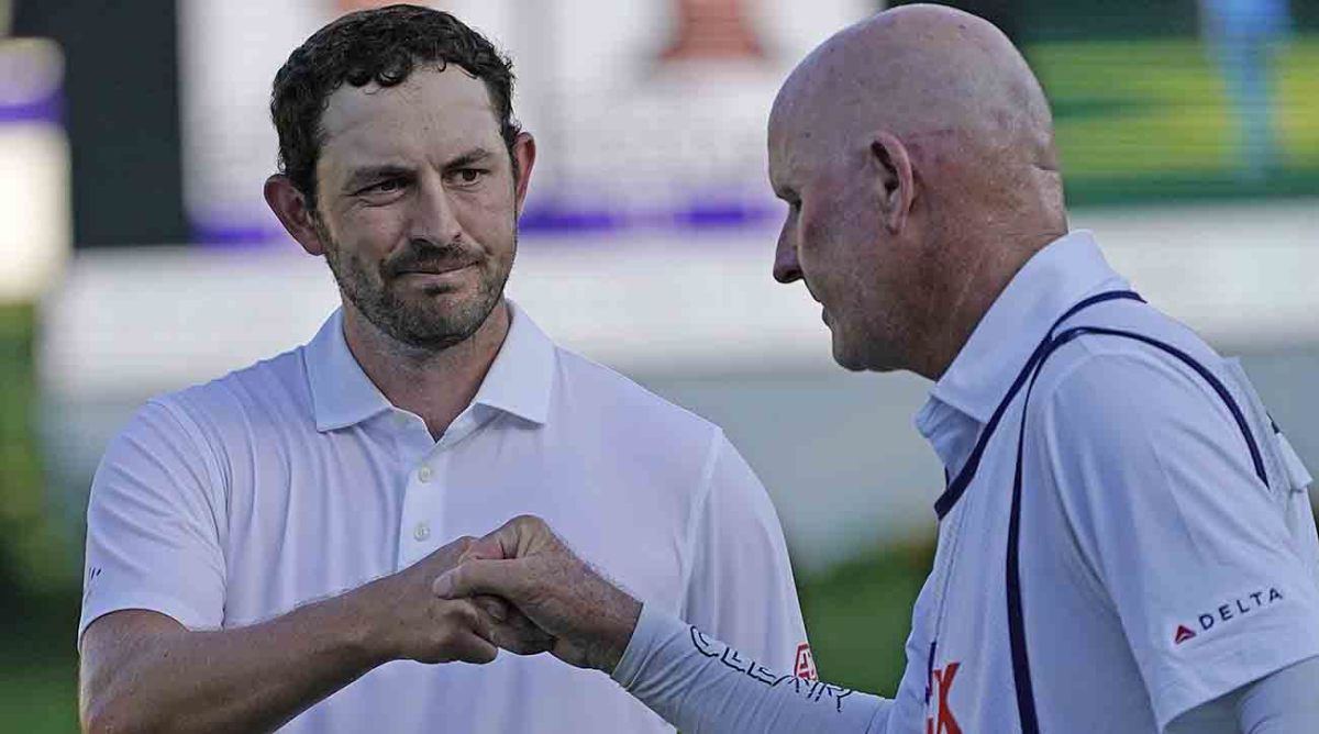 Patrick Cantlay, left, bumps fists with caddie Joe LaCava on the 18th green during the final round of the 2023 St. Jude Championship.
