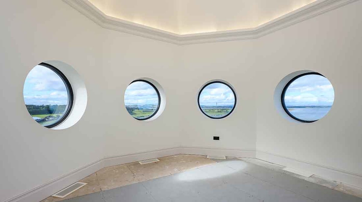 The turret windows from Grand Hamilton Apartment 24 overlook all of St. Andrews' Old Course and the sea.