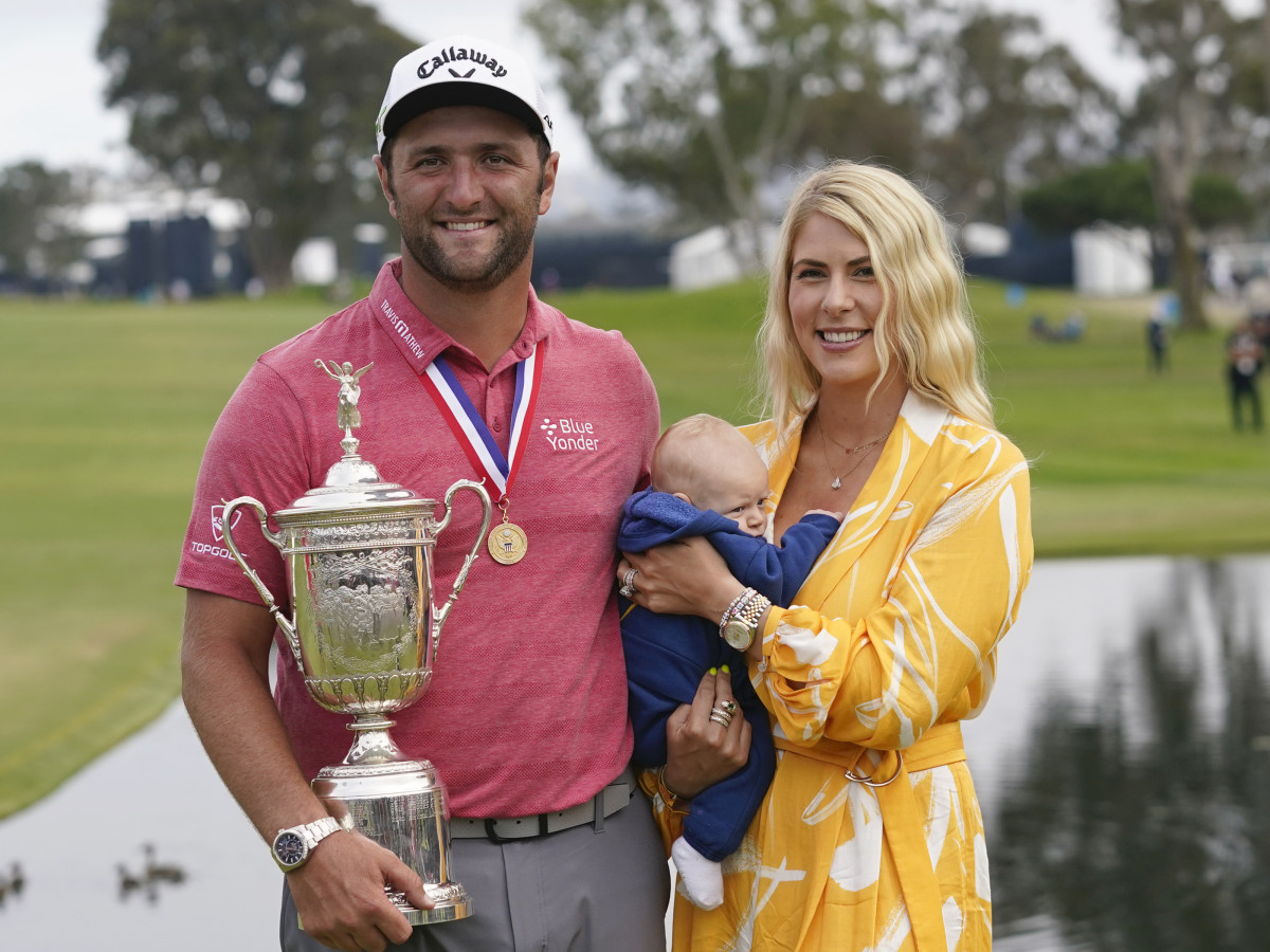 Jon Rahm celebrates holding the trophy as he poses with his wife Kelley Cahill and son Kepa Cahill Rahm after winning he U.S. Open golf tournament at Torrey Pines Golf Course.