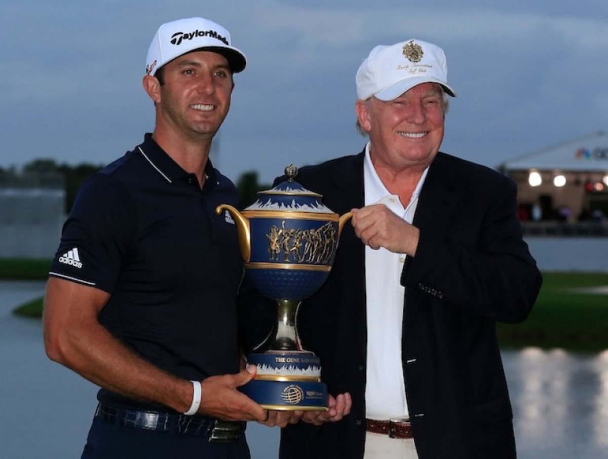 Donald Trump (right) presents the trophy to winner Dustin Johnson at the 2015 WGC Cadillac Championship at Trump National Doral in Florida. 