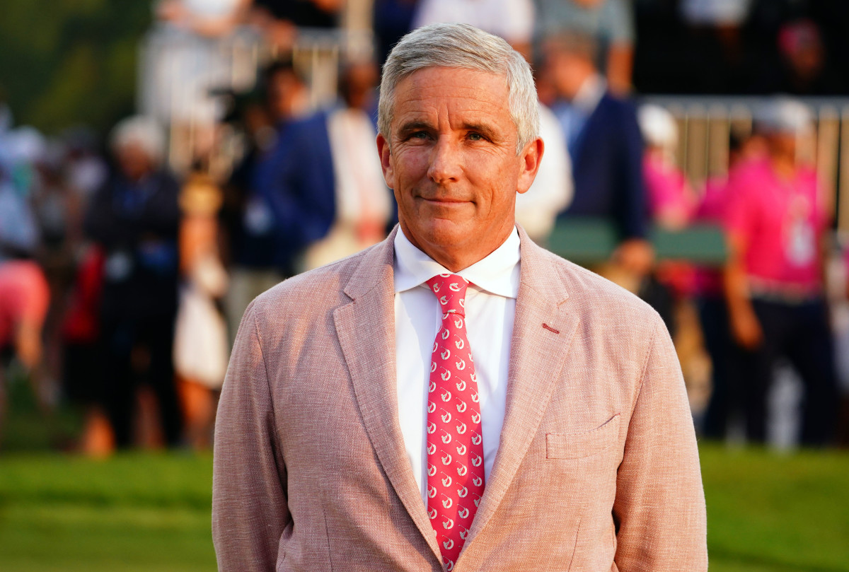 PGA TOUR commissioner Jay Monahan waits on the 18th green during the final round of the TOUR Championship golf tournament at East Lake Golf Club.