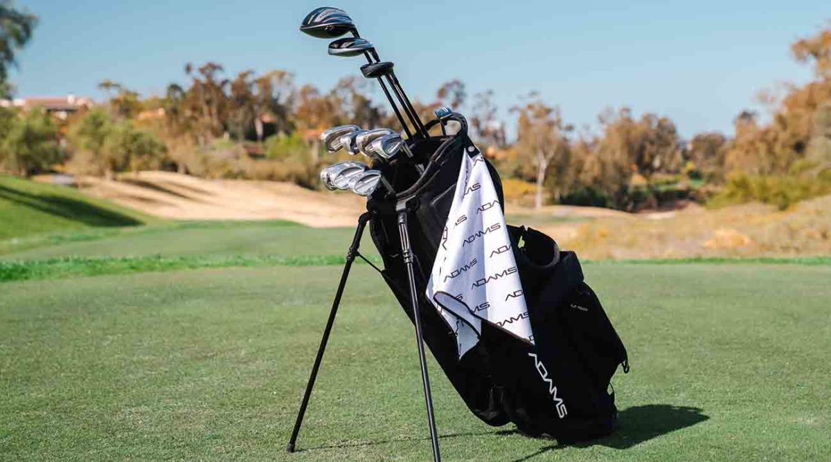 A full bag of Adams Golf clubs, complete with branded accessories.