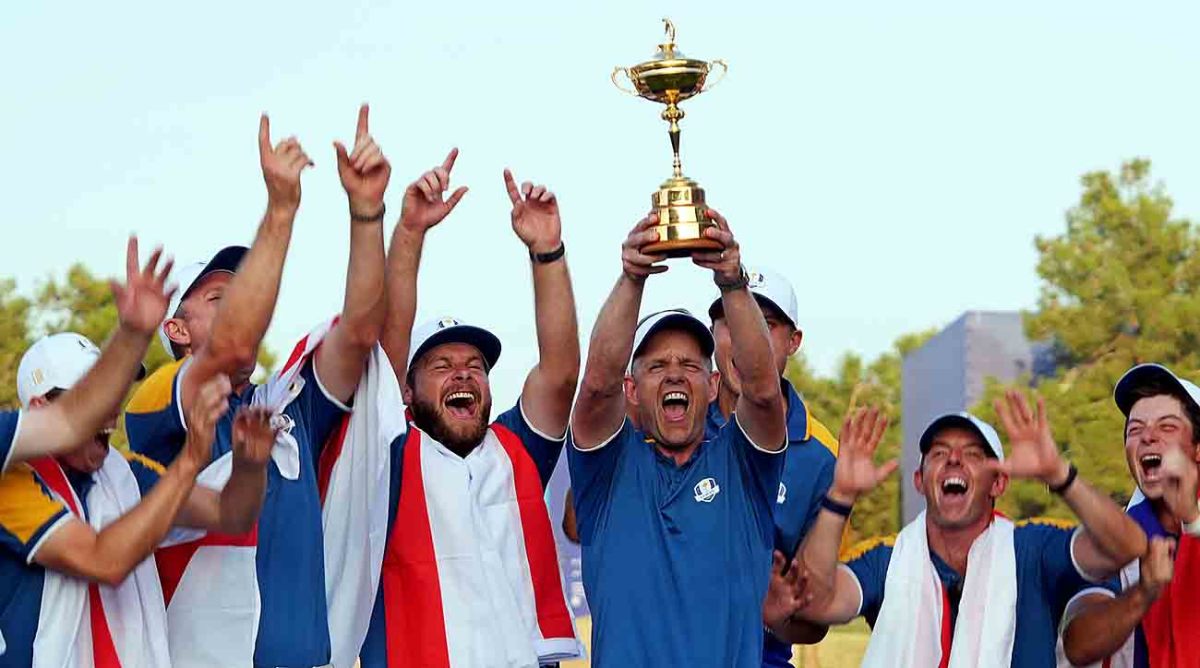 Team Europe captain Luke Donald and Team Europe celebrates with the Ryder Cup after beating Team USA during the final day of the 2023 Ryder Cup at Marco Simone Golf and Country Club.