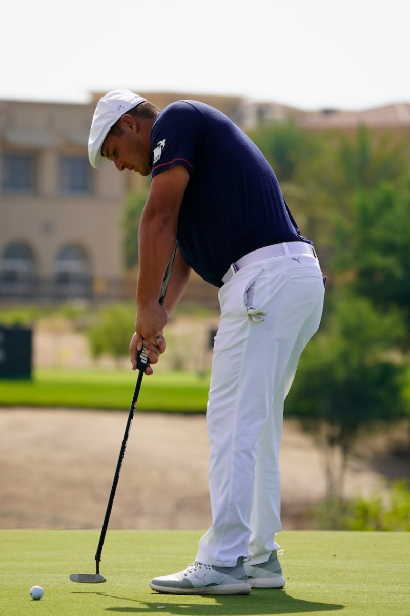 Bryson DeChambeau uses the arm-lock putting method.