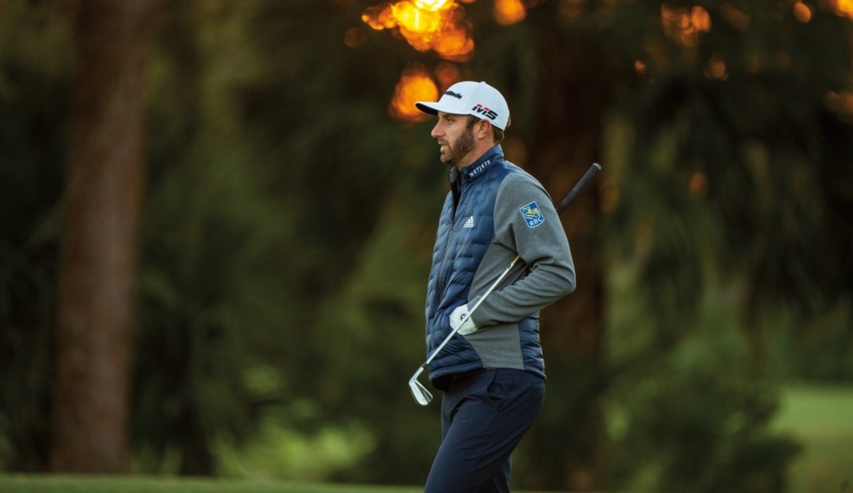 Two-time major champion Dustin Johnson stays warm with Adidas' Frostguard insulated jacket in Collegiate navy blue.