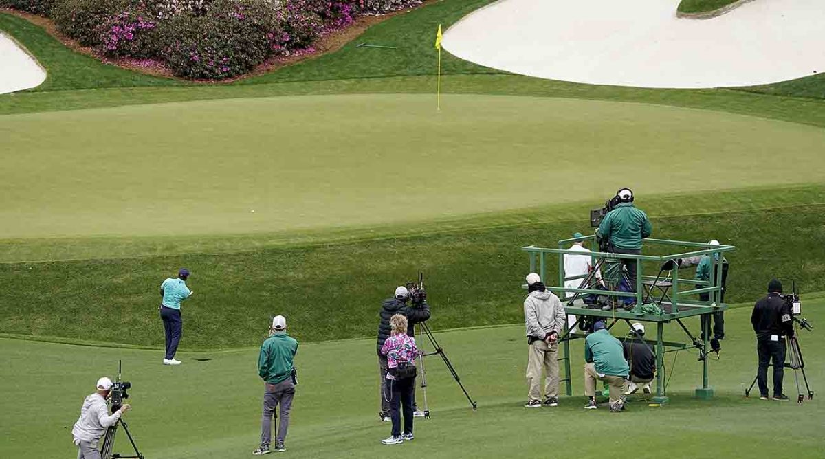 Tiger Woods hits up to the 13th green as cameras watch at the 2022 Masters.