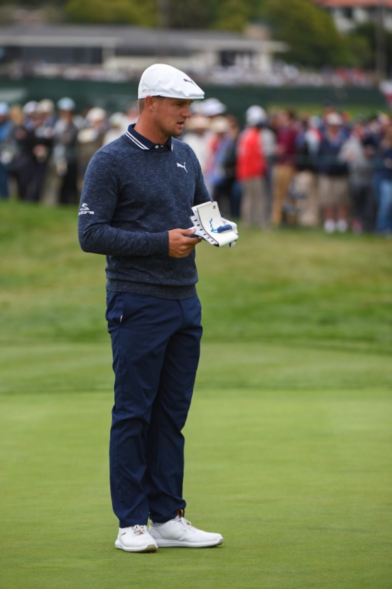 Bryson DeChambeau, consulting his green book earlier this season, has personified the slow-play debate.