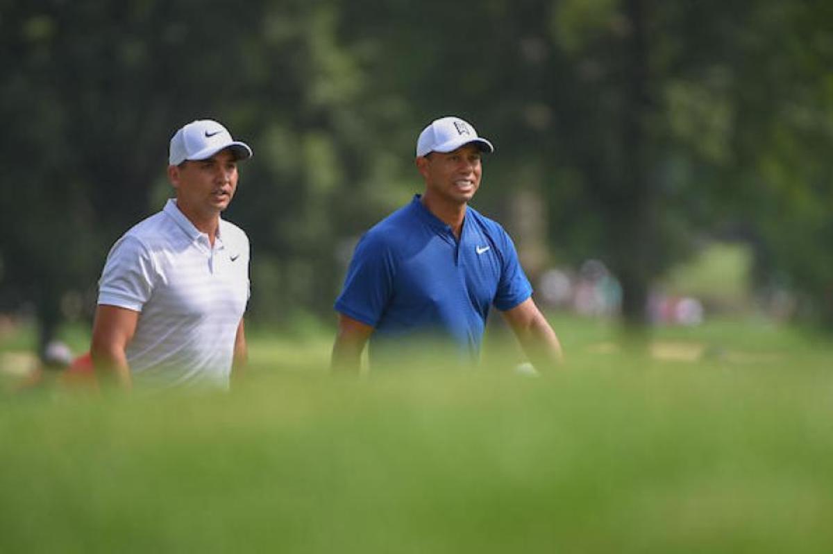 Jason Day (left) gets a close-up of Tiger Woods and his attempt to turn back the clock during the 1st round of the WGC Bridgestone Invitational.