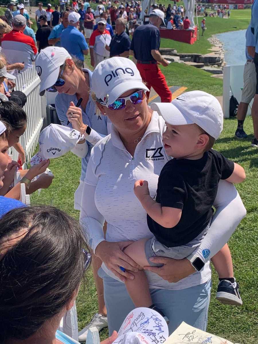 Jackie Stoelting and son Baren meeting the crowds after a round.