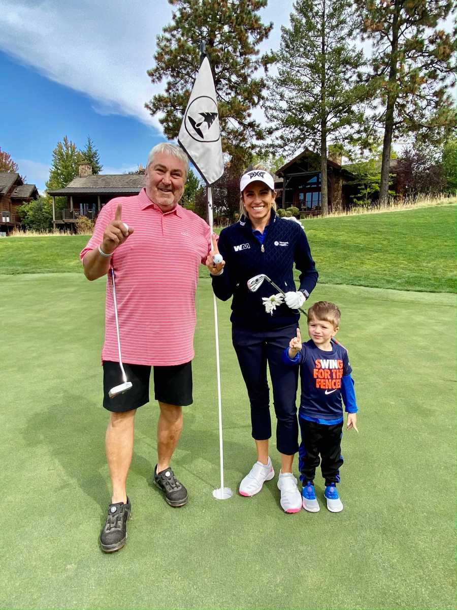 Gerina Mendoza celebrates a practice round hole-in-one with son A.J. and a family friend.