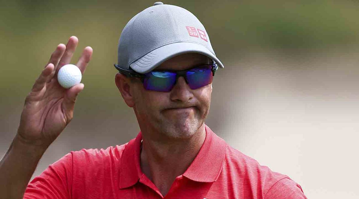 Adam Scott waves to the crowd at the 2022 Australian Open.