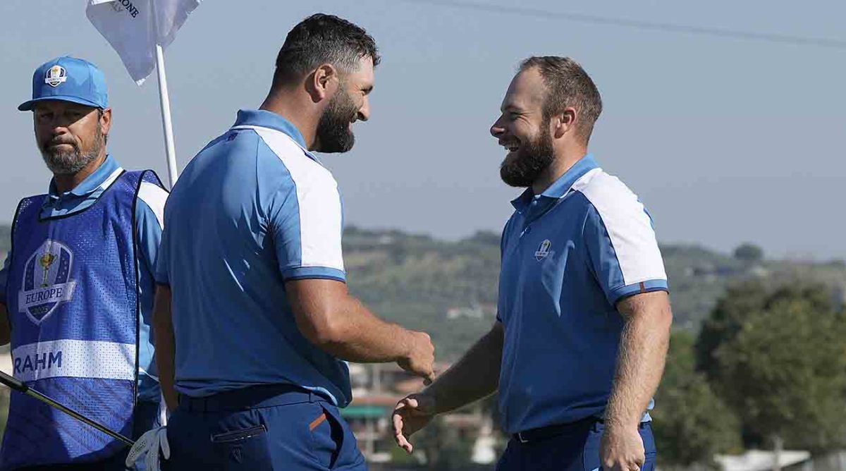 Europe's Jon Rahm, left and playing partner Europe's Tyrrell Hatton celebrate on the 15th green after winning their morning Foursome match 4 and 3 at the Ryder Cup golf tournament at the Marco Simone Golf Club in Italy, Friday, Sept. 29, 2023.