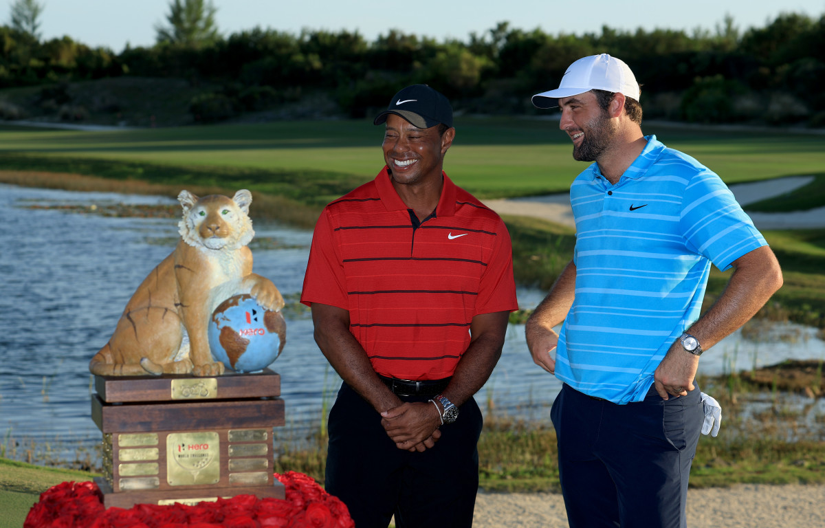 Scottie Scheffler of The United States beside the Hero World Challenge Trophy with tournament host Tiger Woods of The United States after his win in the final round of the Hero World Challenge at Albany Golf Course on December 03, 2023 in Nassau.