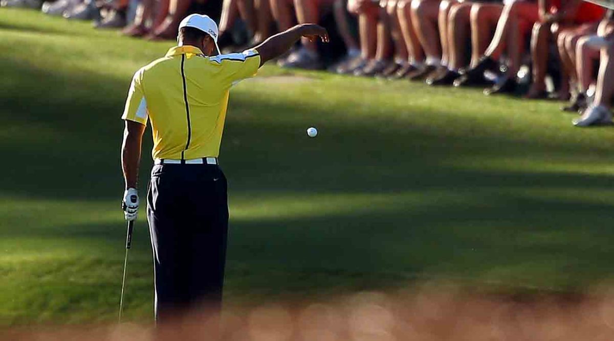 Tiger Woods takes a drop after his third shot rolled into the water at the 15th hole in the second round of the 2023 Masters.