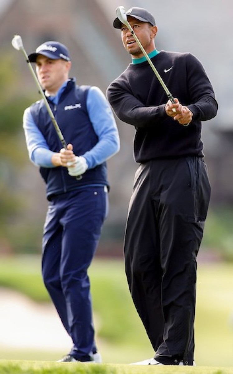 Justin Thomas (left) and Tiger Woods