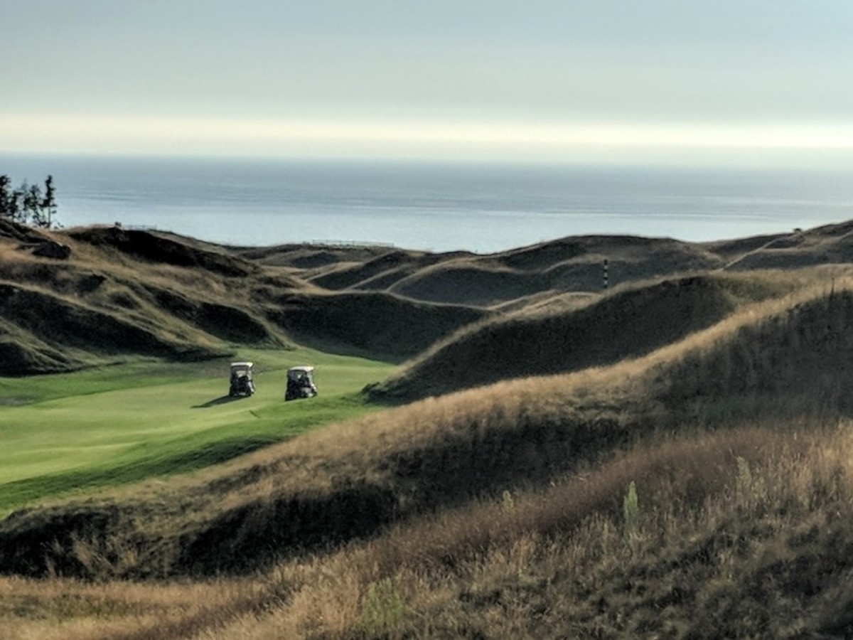 Extensive mounding shapes Arcadia Bluffs, with Lake Michigan as the backdrop.