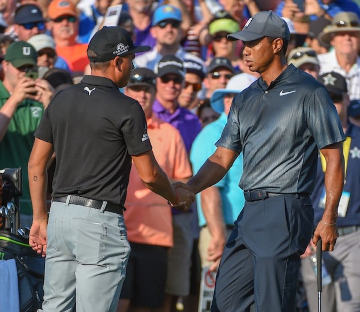 Tiger Woods (right) could be extending a hand to Rickie Fowler (left) soon, should injured Brooks Koepka not be able to play in the Presidents Cup. 
