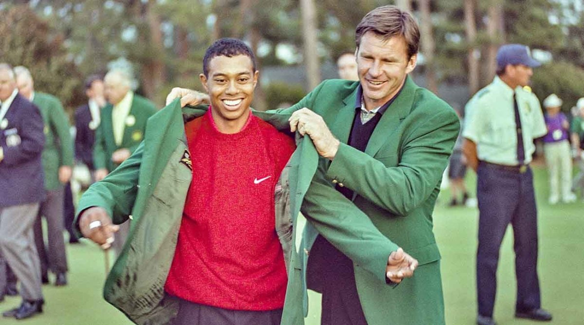 Tiger Woods receives the green jacket from Nick Faldo at the 1997 Masters.