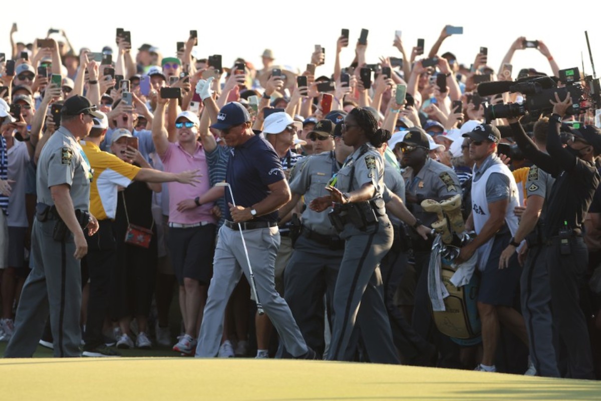 Phil Mickelson break through the swarming gallery to approach the 18th hole and victory Sunday in the PGA Championship at Kiawah Island's Ocean Course. 