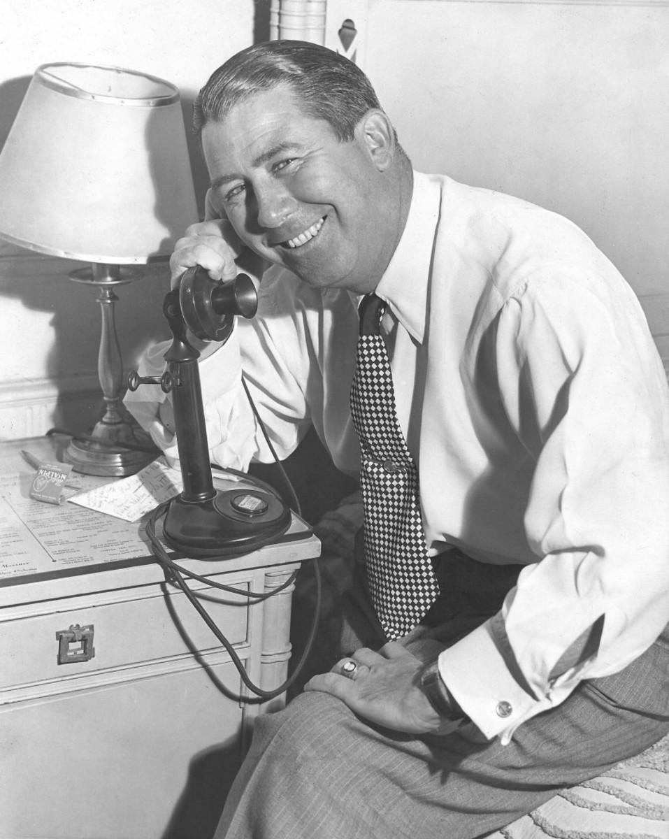 The late Fred Corcoran, doing what he did best in promoting the upstart LPGA: working the phone. 