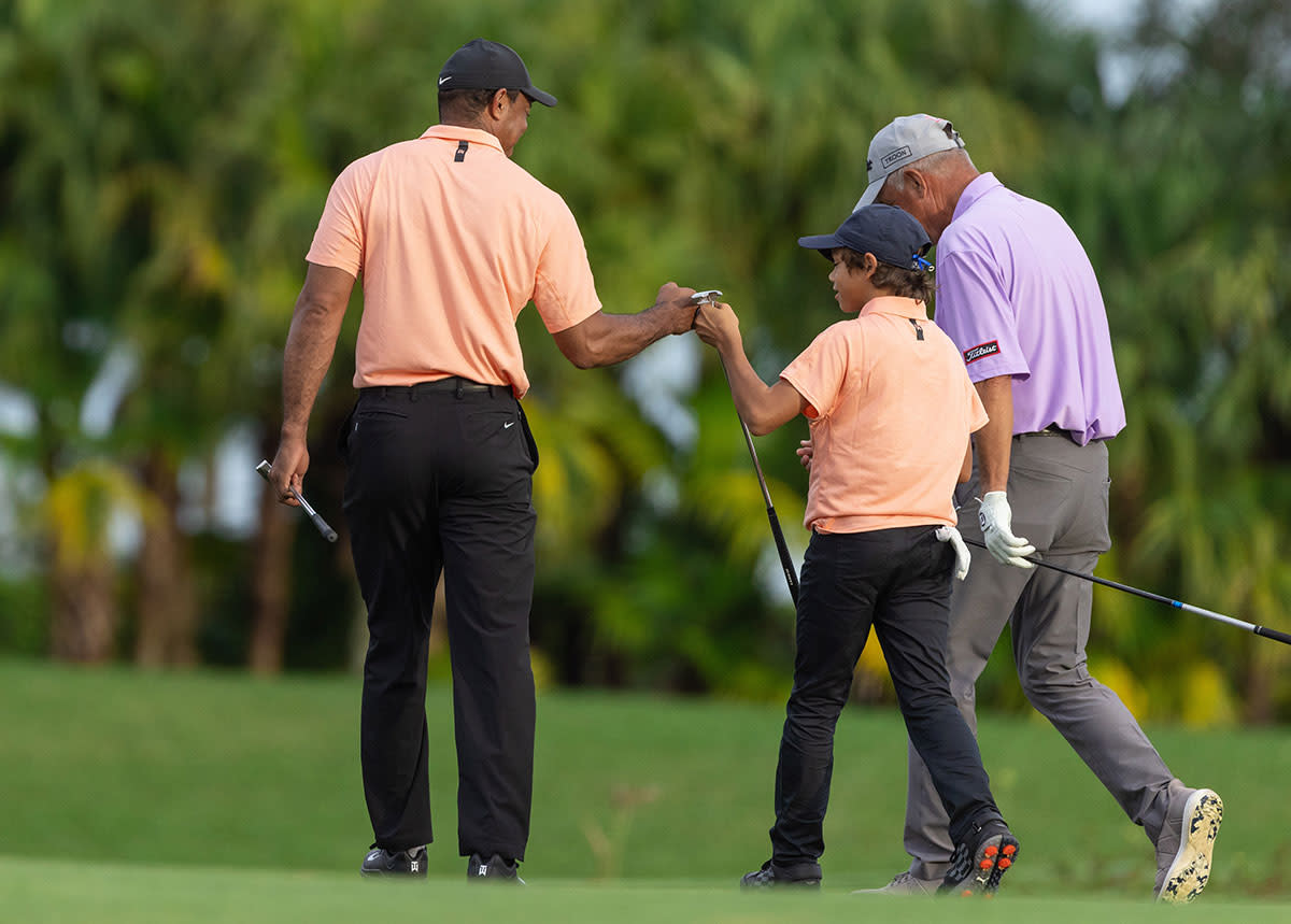 Tiger Woods and Charlie Woods fist-bump.