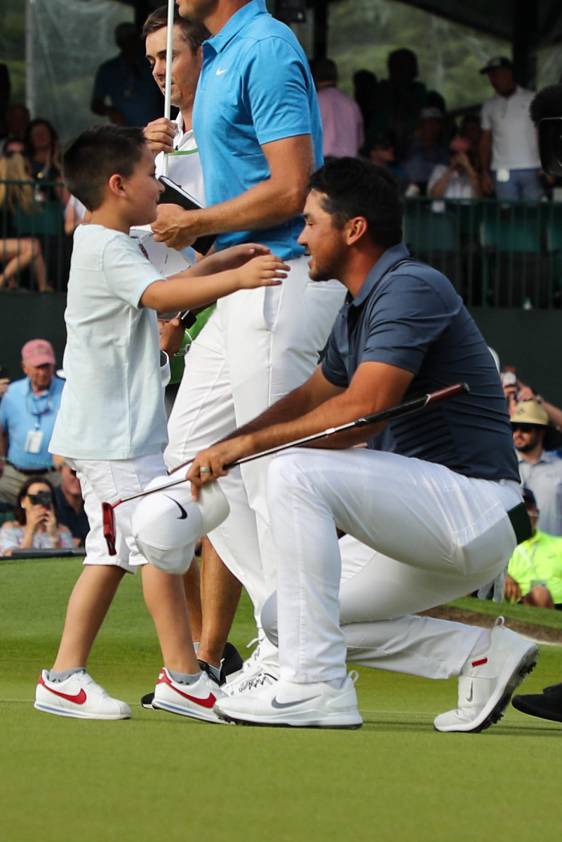 Dash Day (left) greets his father on the final green when Jason Day won the 2018 Wells Fargo Championship in Charlotte, N.C.