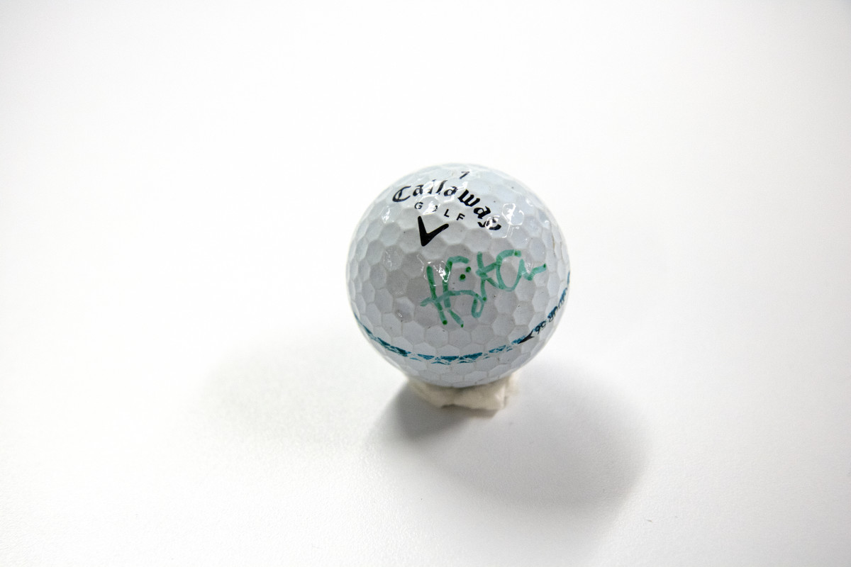 A golf ball signed by professional Tadd Fujikawa.