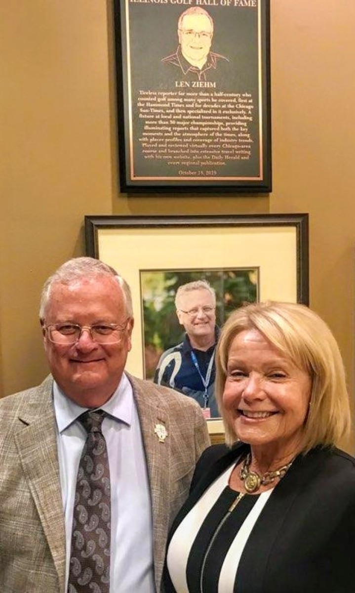Len Ziehm and Joy Sarver pose in front of Ziehm’s plaque during induction ceremonies for the Illinois Golf Hall of Fame.