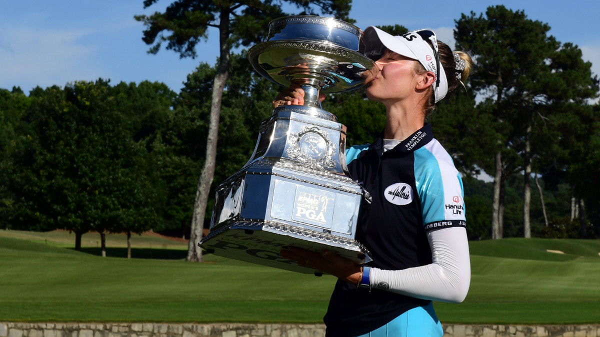 Nelly Korda poses with the championship trophy as she celebrates winning the KPMG Women's PGA Championship golf tournament at the Atlanta Athletic Club.