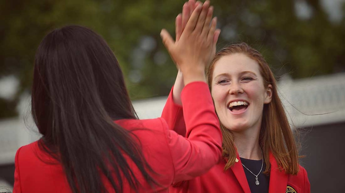 Emilia Migliaccio high fives Rose Zhang as they learn they are paired together in Friday morning Four-Ball at the 2022 Curtis Cup.