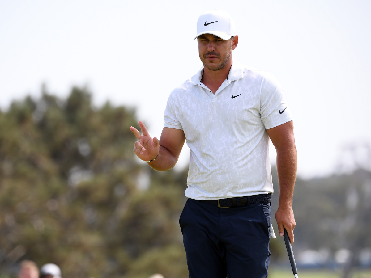 Brooks Koepka waves after his putt on the 12th green during the first round of the U.S. Open golf tournament at Torrey Pines Golf Course.
