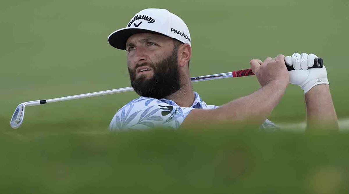 Jon Rahm from Spain plays a bunker shot on the first hole during the 2023 DP World Tour Championship golf tournament in Dubai, United Arab Emirates.