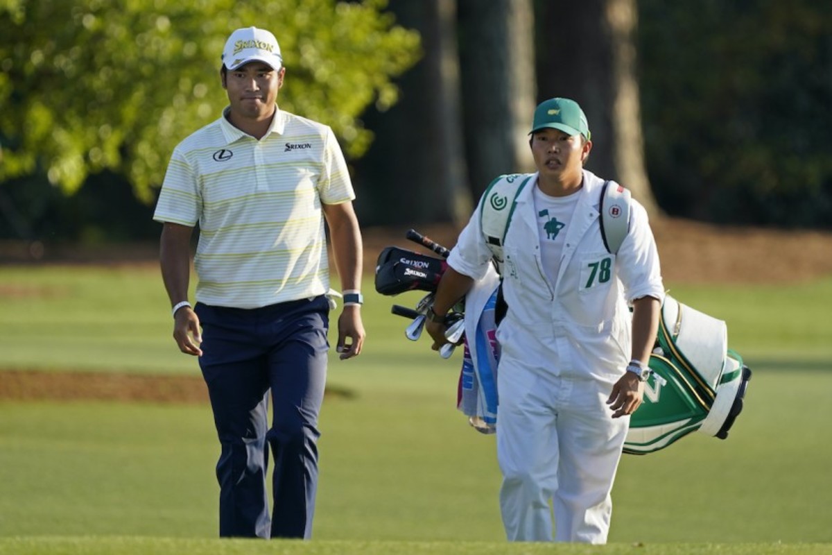 Japan's Hideki Matsuyama walks to the 18th green with caddie Shota Hayafuji during the final round of the Masters at Augusta National Golf Club on Sunday.