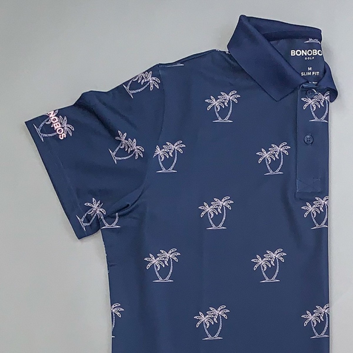 Bonobos' Performance Golf Polo shirt in navy with a neon palms print.