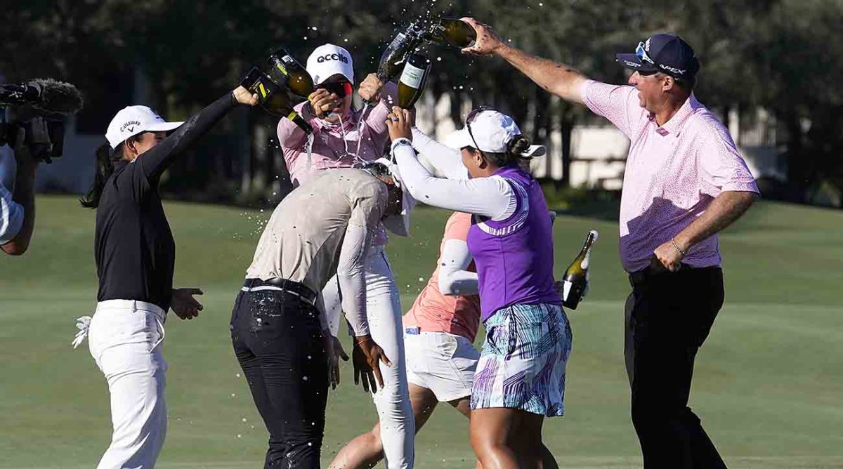 Amy Yang second from left, is sprayed with champagne after winning the 2023 LPGA CME Group Tour Championship.