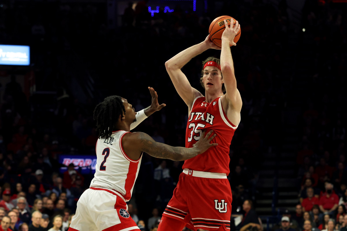 Jan 6, 2024; Tucson, Arizona, USA; Utah Utes center Branden Carlson (35) makes a pass against Arizona Wildcats guard Caleb Love (2) during the first half at McKale Center. Mandatory Credit: Zachary BonDurant-USA TODAY Sports