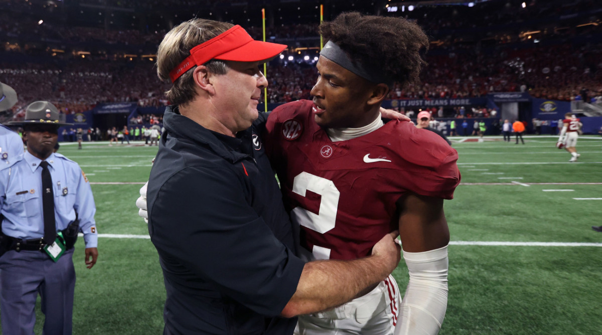 Georgia coach Kirby Smart embraces Alabama star safety Caleb Downs after the SEC championship.