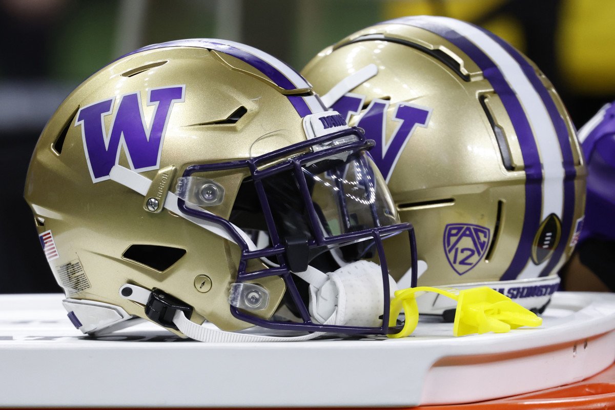 an 1, 2024; New Orleans, LA, USA; Washington Huskies players' helmets rest on a cooler on the bench against the Texas Longhorns in the 2024 Sugar Bowl college football playoff semifinal game at Caesars Superdome. Mandatory Credit: Geoff Burke-USA TODAY Sports