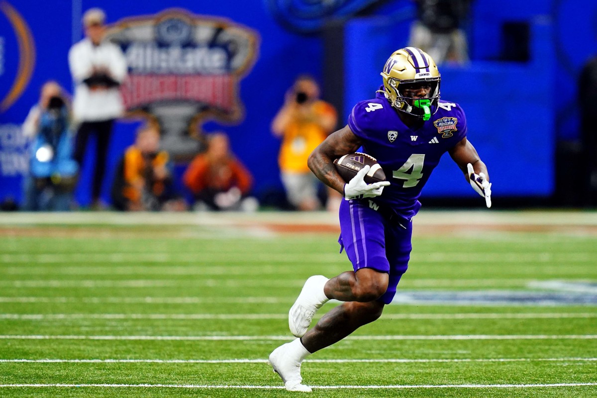 Jan 1, 2024; New Orleans, LA, USA; Washington Huskies wide receiver Germie Bernard (4) runs with the ball during the third quarter against the Texas Longhorns in the 2024 Sugar Bowl college football playoff semifinal game at Caesars Superdome. Mandatory Credit: John David Mercer-USA TODAY Sports