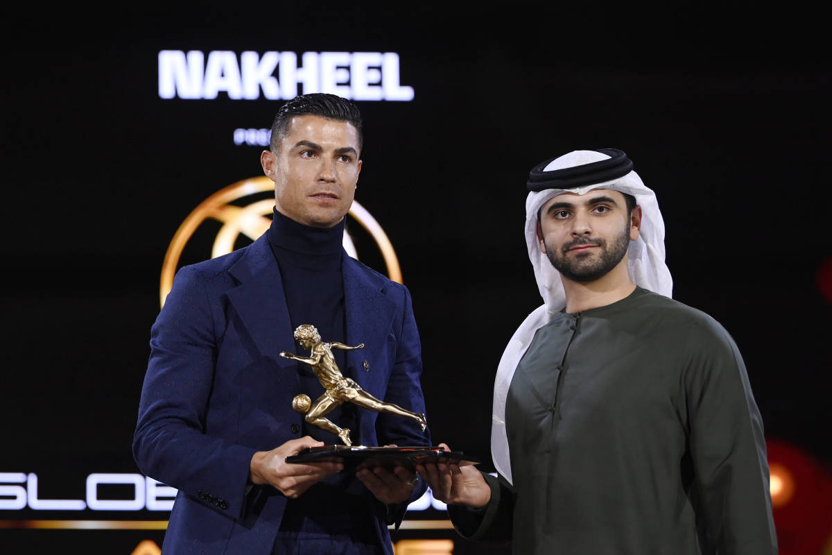 Cristiano Ronaldo pictured (left) collecting a trophy at the 2023 Dubai Globe Soccer Awards in January 2024