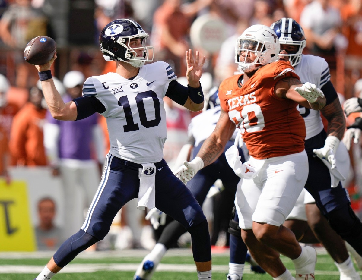 BYU Cougars quarterback Kedon Slovis throws under press ure from Texas Longhorns defensive lineman Byron Murphy II in the first quarter at Royal-Memorial Stadium on Saturday October 28, 2023.  