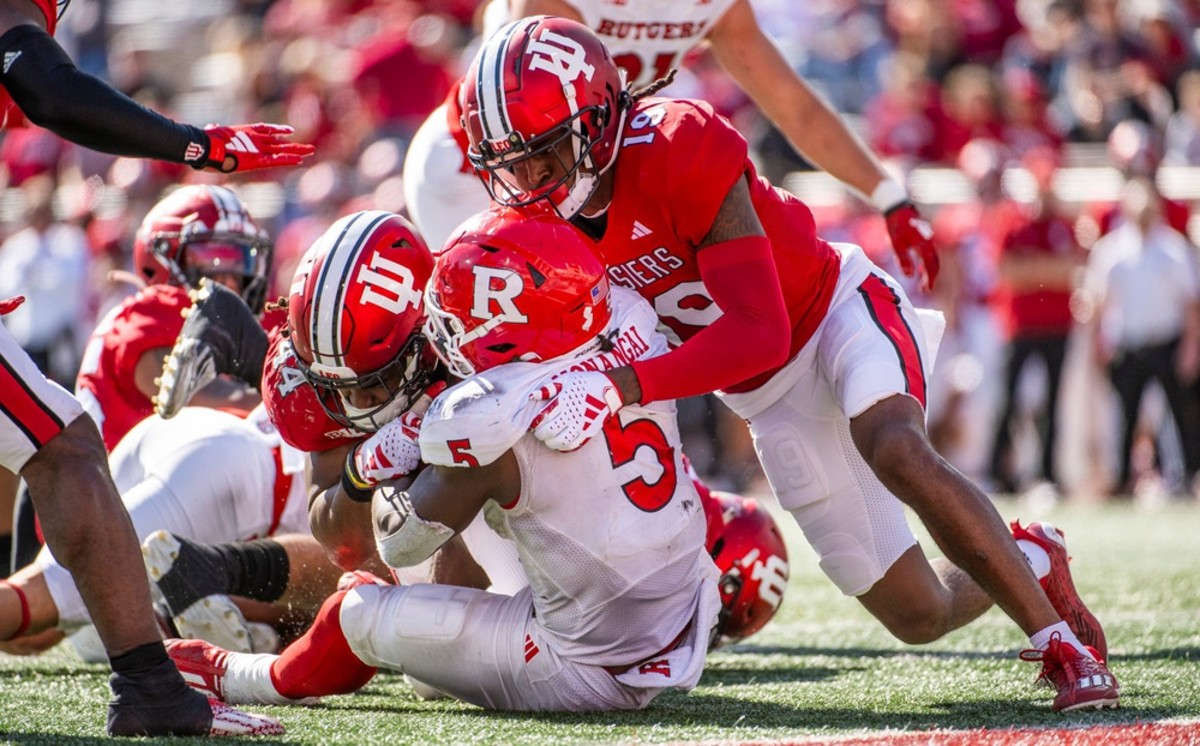 Indiana's Aaron Casey (44) and Josh Sanguinetti (19) tackle Rutgers' Kyle Monangai (5) during the second half of the Indiana versus Rutgers football game at Memorial Stadium on Saturday, Oct. 21. 2023.  