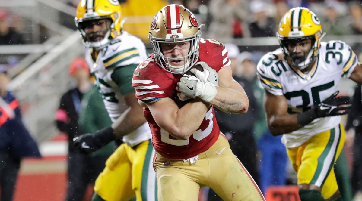 San Francisco 49ers running back Christian McCaffrey (23) crosses the goal line for the decisive touchdown late in the fourth quarter of a playoff games against the Packers.