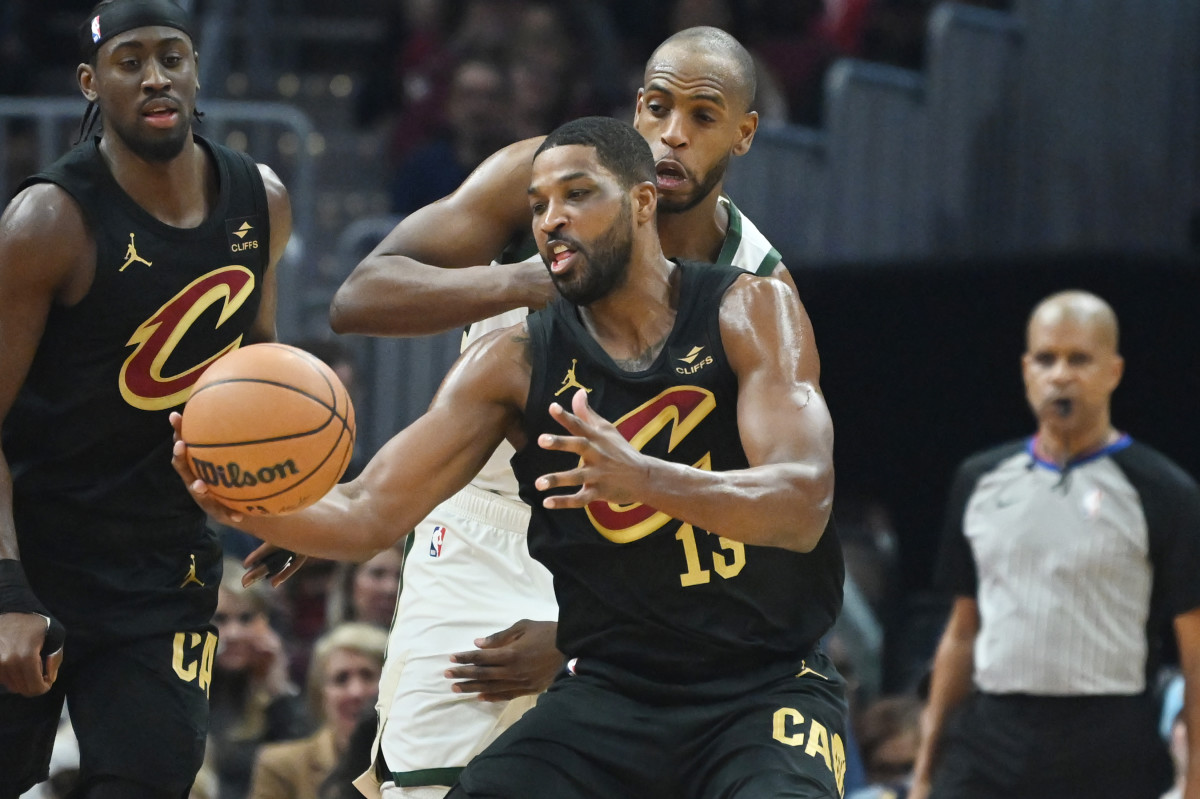 Jan 17, 2024; Cleveland, Ohio, USA; Milwaukee Bucks forward Khris Middleton (22) goes for a loose ball against Cleveland Cavaliers center Tristan Thompson (13) during the first half at Rocket Mortgage FieldHouse.