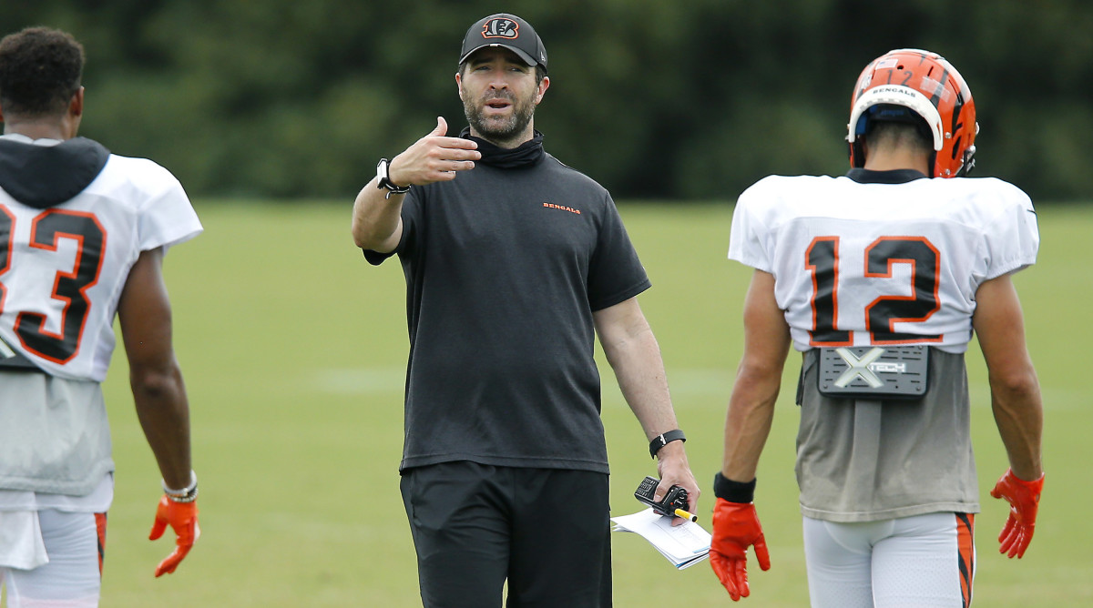 Brian Callahan ushers with his hand as players walk toward him