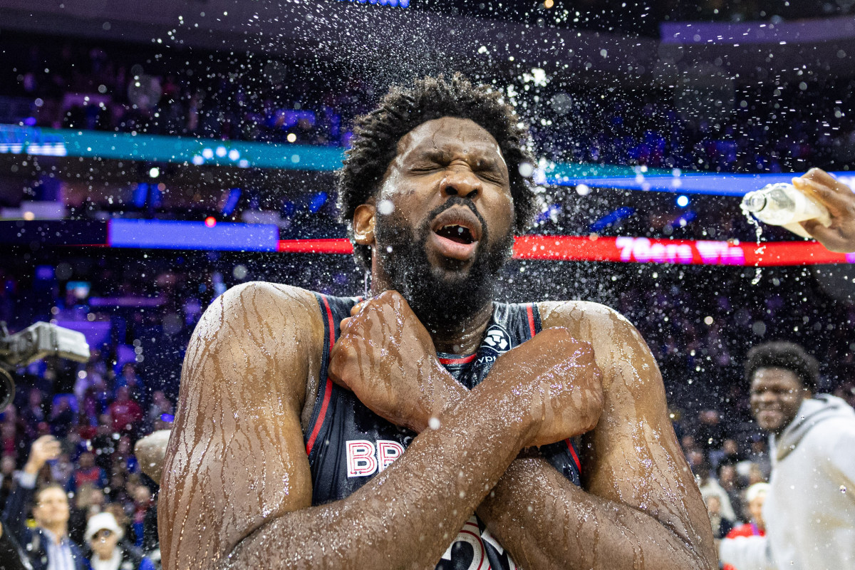 Jan 22, 2024; Philadelphia, Pennsylvania, USA; Philadelphia 76ers center Joel Embiid (21) is doused with water by teammates after scoring 70 points in a victory against the San Antonio Spurs at Wells Fargo Center.